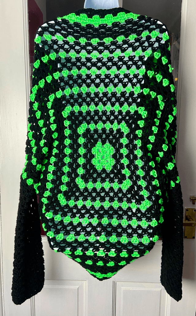 Neon green and black shrug style cardigan.
