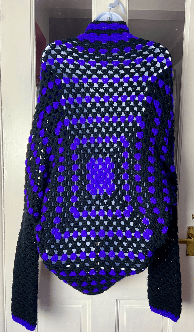 Purple and black shrug style cardigan.