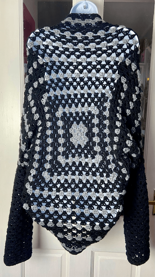 Grey and black shrug style cardigan.