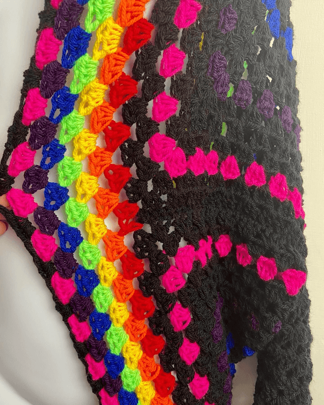 Rainbow and black shrug style cardigan.