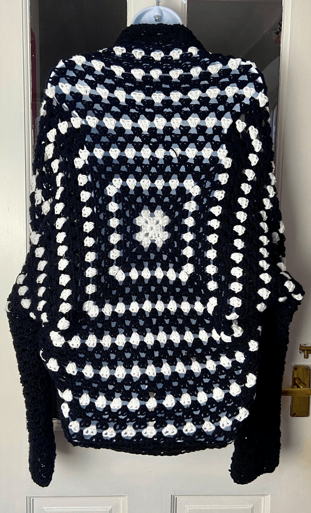 Black and white shrug style cardigan.