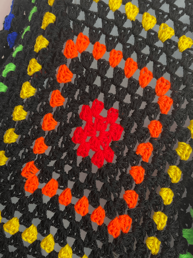 Rainbow and black shrug style cardigan.