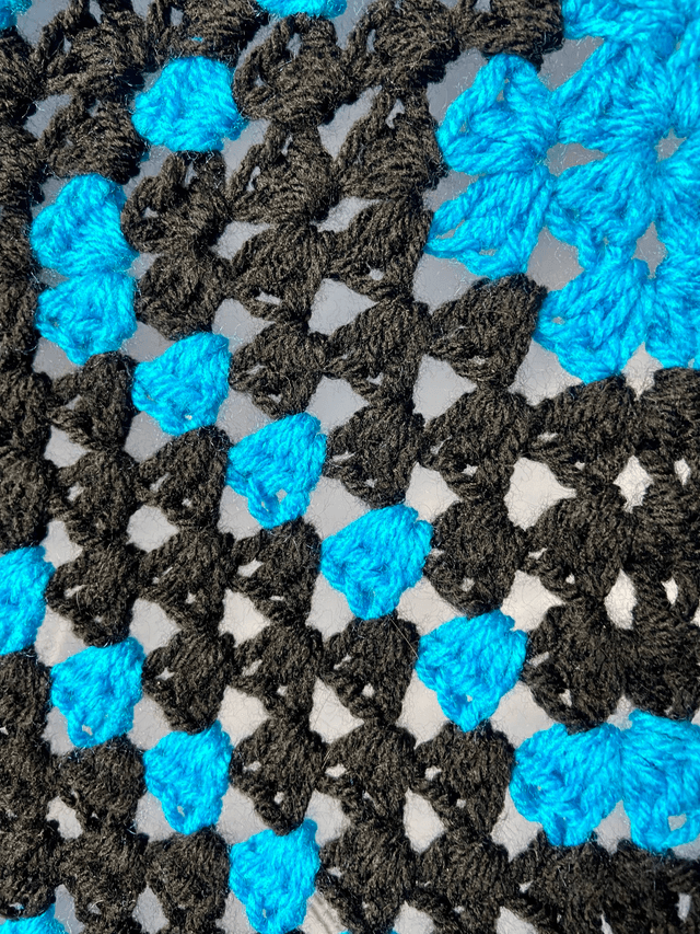 Blue and black shrug style cardigan.