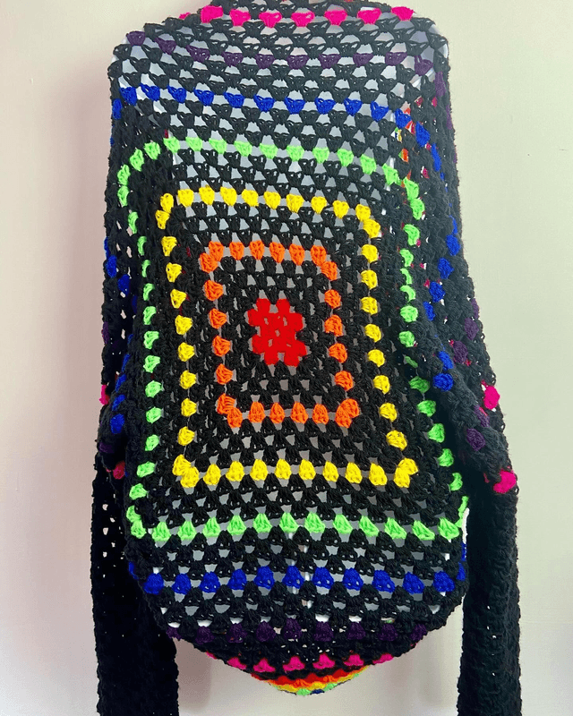 Rainbow and black shrug style cardigan.