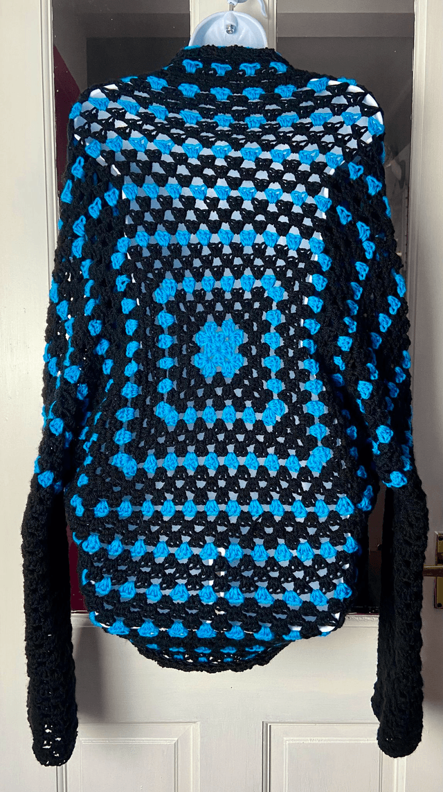 Blue and black shrug style cardigan.