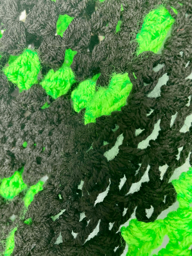 Neon green and black shrug style cardigan.
