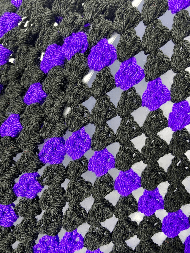 Purple and black shrug style cardigan.