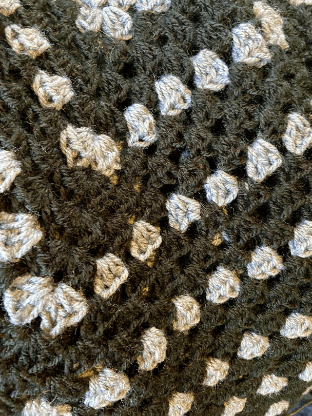 Grey and black shrug style cardigan.