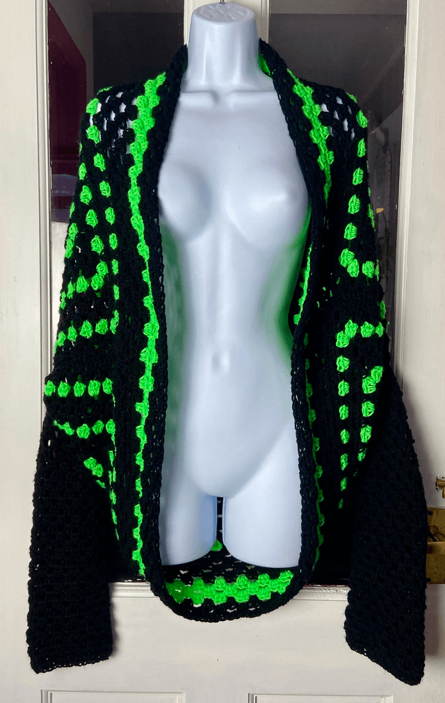 Neon green and black shrug style cardigan.